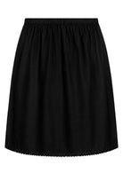Black slight A-line cotton slip skirt with elasticated waist and picot trim on hem, front view