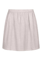 White slight A-line cotton slip skirt with elasticated waist and picot trim on hem, back view