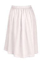 White slight A-line cotton slip skirt with elasticated waist and picot trim on hem, side view