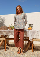Woman wearing a cotton Floral long-sleeve top in dune print with scoop neck 