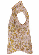 Side view of loose fit shirt style cotton top with collar in cream based floral print