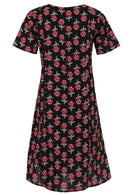 Back view of cotton dress with round neckline in black based floral print. 