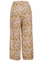 Back view of 100% cotton wide leg pants with elastic waist and pockets in cream based floral print