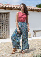 woman wearing wide legged blue based floral print rayon pants with a basic top