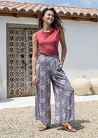 woman wearing wide legged blue based floral print rayon pants with a basic top