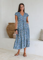 Model wears rayon maxi dress with tiered, voluminous skirt and elasticated waistband