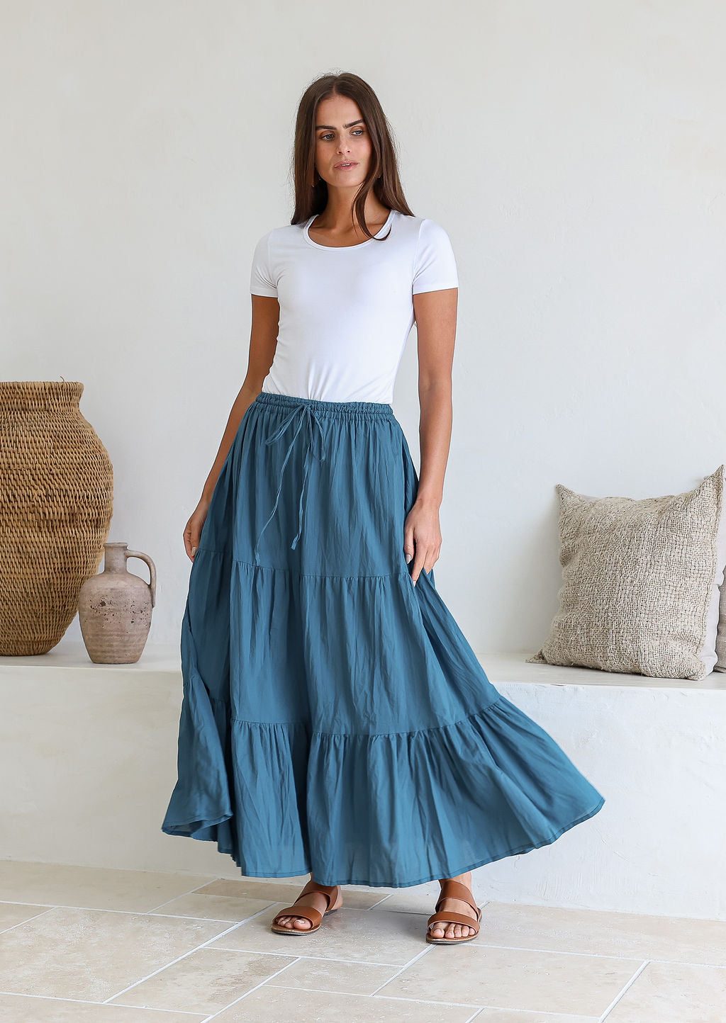 Model wearing a 100% cotton skirt in plain deep blue shade paired with a white top