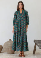 Model wearing 100% cotton flowy three tiered maxi dress with buttoned bodice, 3/4 sleeves and hidden side pockets 