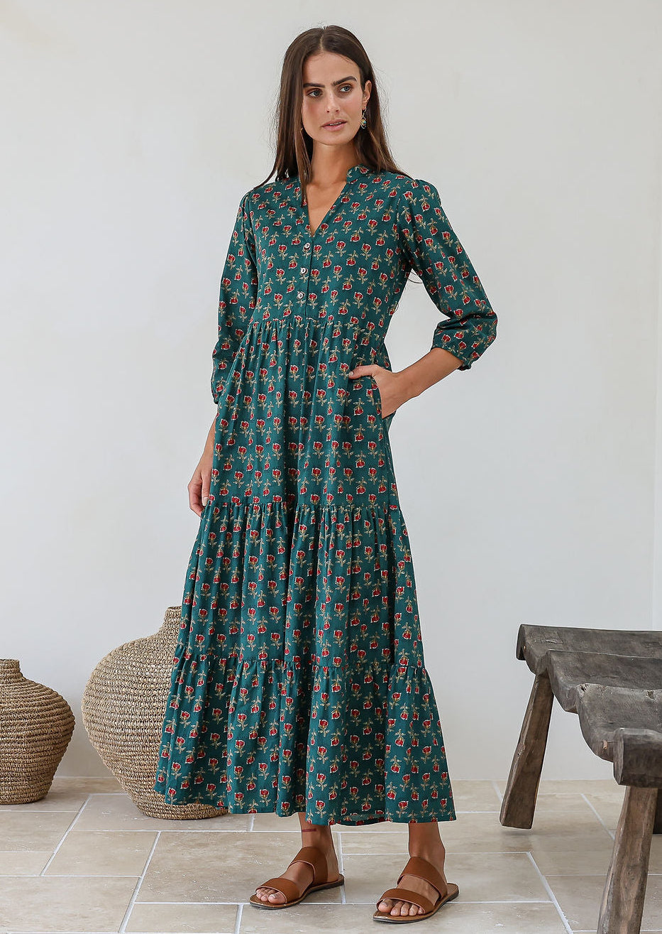 Woman wearing relaxed fit floral printed cotton maxi dress in green with 3/4 sleeves, pockets and three tiered skirt
