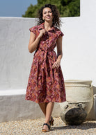 Model posing in a Japanese style floral print shirt style 100% cotton dress with cap sleeves and detachable waist tie