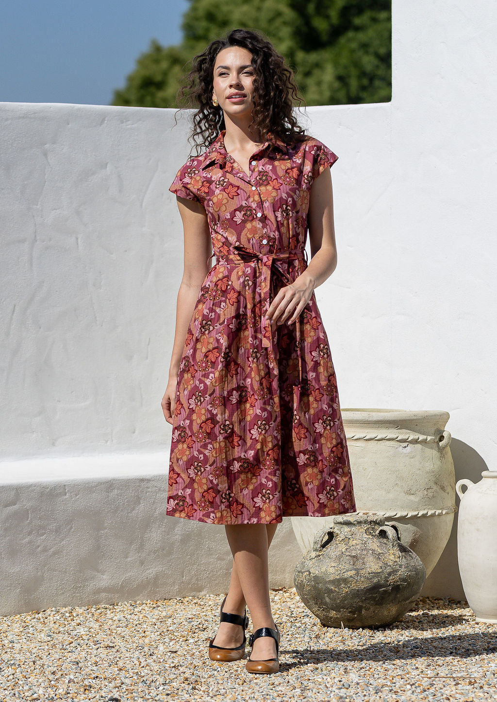 Model posing in a Japanese style floral print shirt style 100% cotton dress with cap sleeves and detachable waist tie