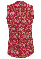 The back view of a red sleeveless blouse with pink and white floral prints, vertical pleats, and a smooth cotton finish for a classic, elegant look.