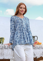 White based blue floral print cotton top with pin tuck detail, long sleeves. 