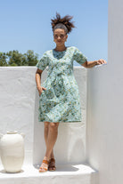 Woman 100% cotton sage green based floral relaxed fit dress with round neckline and short sleeves.