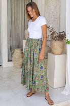Model pairs crinkled, floral cotton maxi skirt with white rayon top 