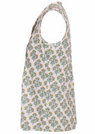 The side view shows a white sleeveless blouse with a yellow and green floral print, button-up collar, pleats, and a slightly flared hem.