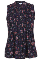 Front view of a sleeveless blouse with pink, blue, and white floral print on a dark base, a button-up collar, front pleats, and a flattering, slightly flared hem.