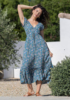 Model standing and wearing 100 percent rayon maxi dress with butterfly
sleeves and v-neck