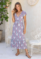 Model standing and wearing 100 percent cotton maxi dress with butterfly
sleeves and v-neck