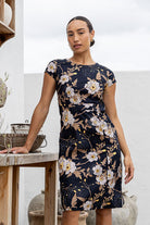 Woman wearing a 100% cotton, knee-length A-line floral dress.