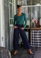 Woman wearing a cotton corduroy wide-leg navy blue pants with hand in pockets