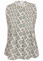 This front-view white sleeveless blouse has a yellow and green floral print, button-up collar, pleats, and a flared hem.