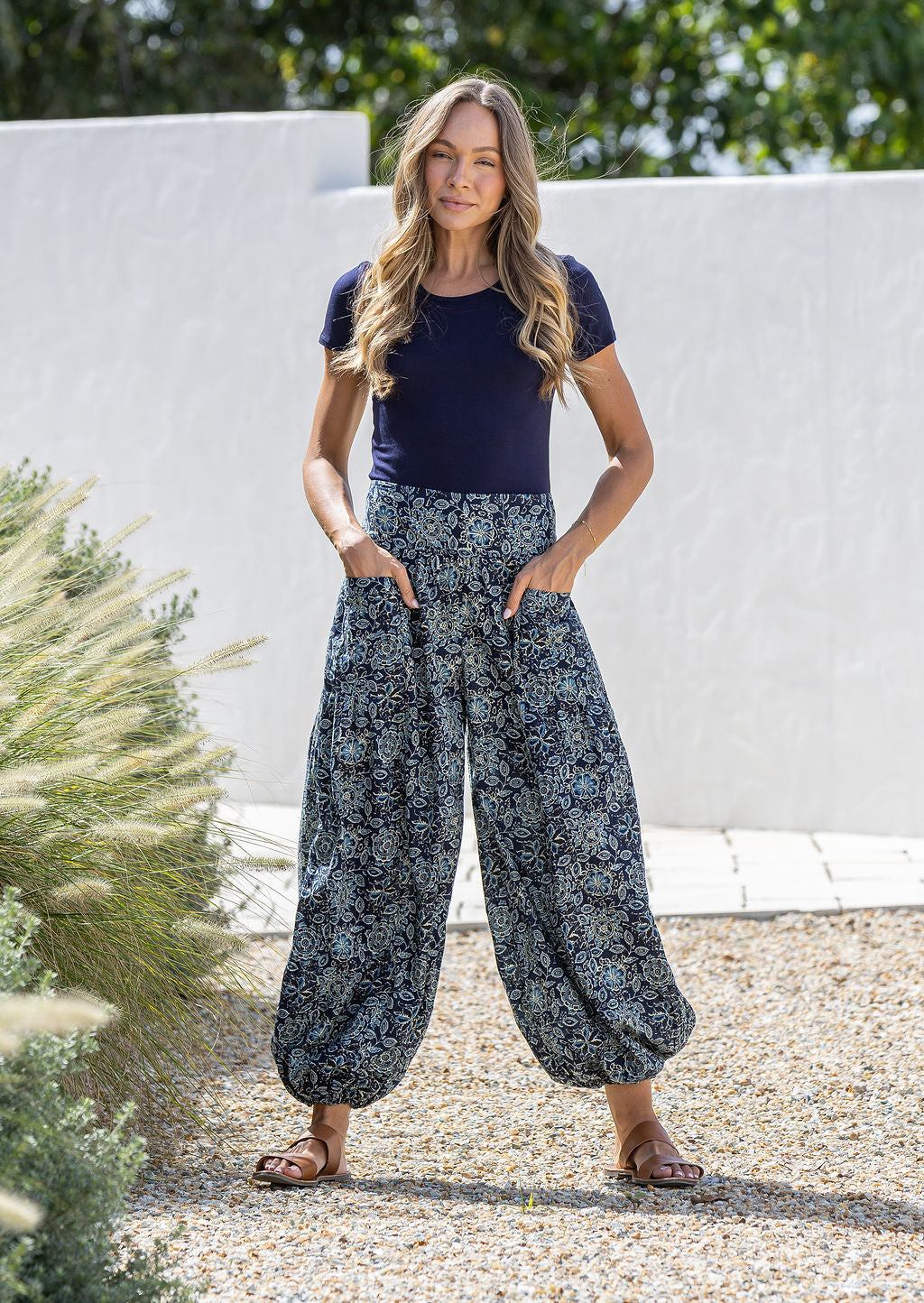 Model wears cotton harem pants with elasticated ankles, wide waistband and deep pockets.