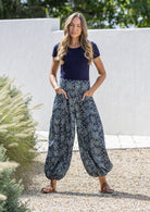 Model wears cotton harem pants with elasticated ankles, wide waistband and deep pockets.