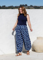 wearing a 100% cotton floral blue harem pants with flat wide waistband in front and elastic at the back.