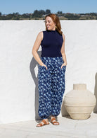 Model wears cotton harem pants with elasticated ankles, wide waistband and deep pockets.