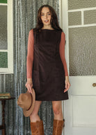 Woman wearing cotton corduroy tunic in ganache dark brown with boat neck and  pocket