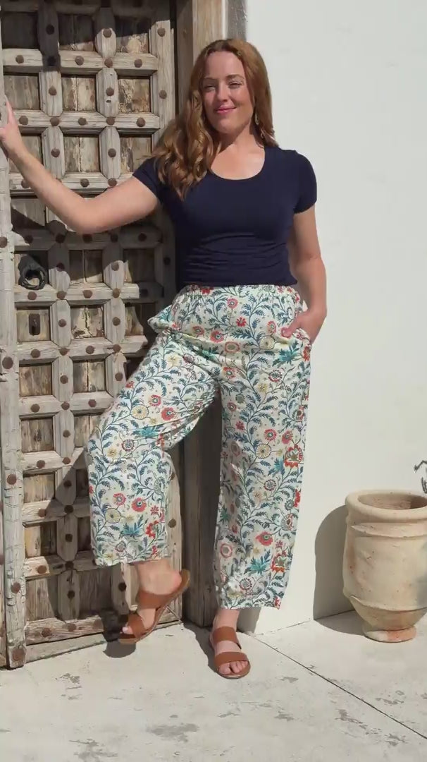 Greta Pants Keepsake video of printed cotton pants on model with red hair in front of wooden door