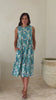 Video of a woman wearing a cotton sleeveless three tiered midi length dress in aqua and royal blue daisy print.
