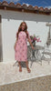 Video of a woman wearing a 100% cotton Pink striped midi dress with floral print, short sleeves. 