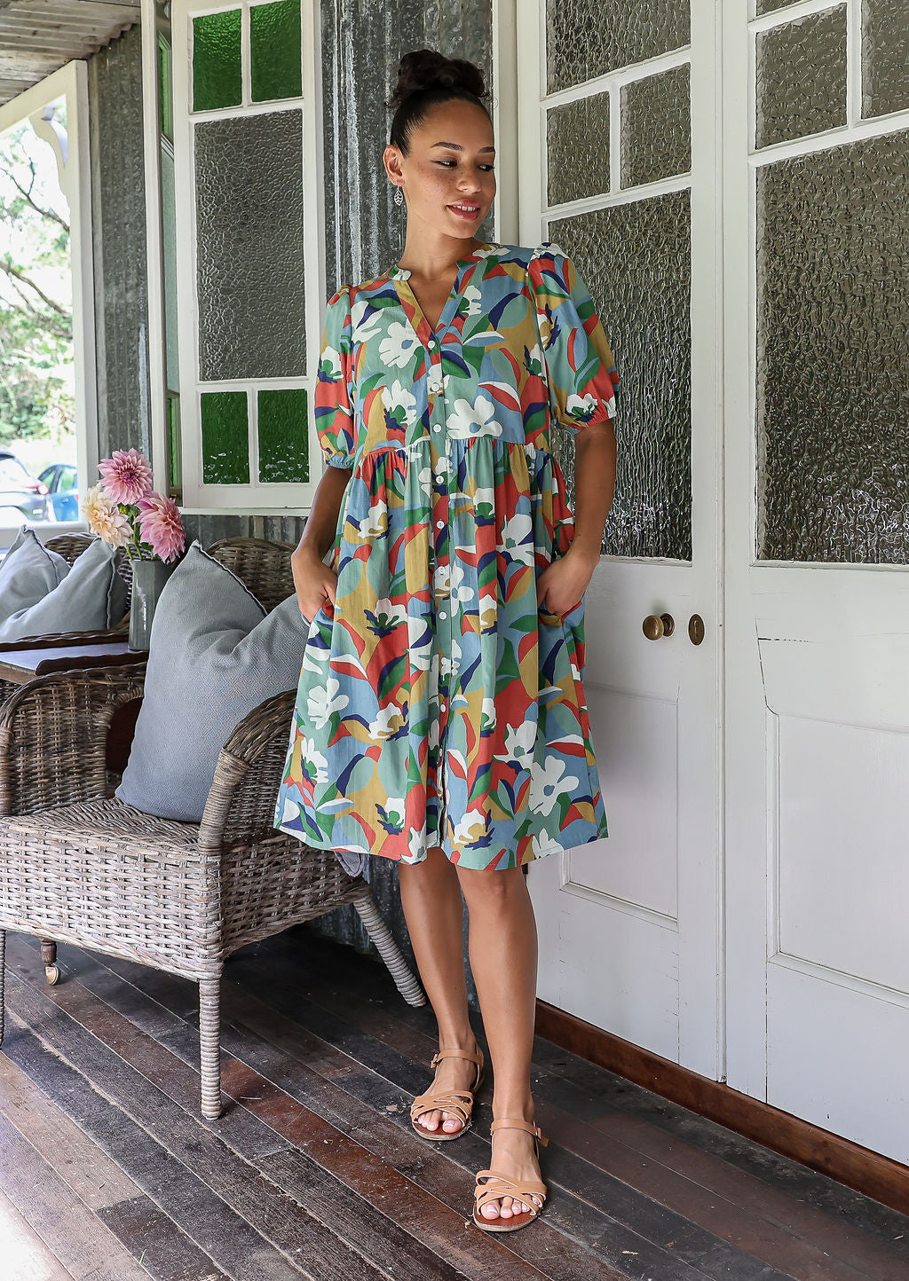 Woman wearing a knee length relaxed fit button through 100% cotton dress with elbow length sleeves