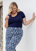 Woman wearing a scoop neck navy blue rayon fitted t-shirt.