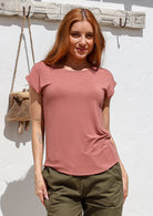 Woman wearing a soft flattering fit dusty pink rayon jersey t-shirt.