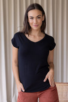 Woman wearing a black soft stretch rayon t-shirt with a V-neck and cap sleeves