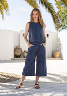 Model wears 100% cotton relaxed fit sleeveless top in navy based white striped print