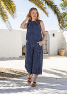 Model stands wearing a sleeveless floral cotton boxy top paired with the same print cotton pants.