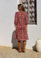 Model stands backwards in cotton over the knee length relaxed fit dress with 3/4 sleeves, paired with brown boots. 