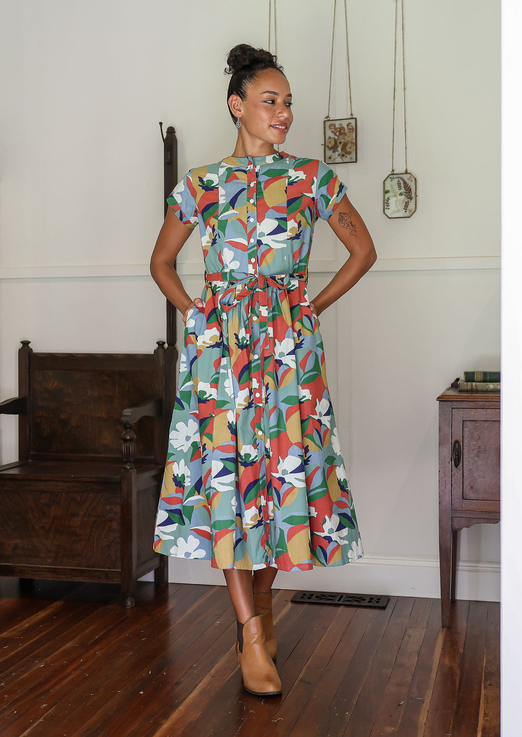 Woman wears 100% cotton button through midi length dress with short sleeves and pockets